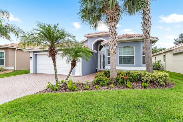 view of front facade with a garage and a front yard