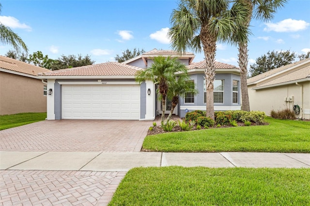 mediterranean / spanish-style home with a garage and a front yard