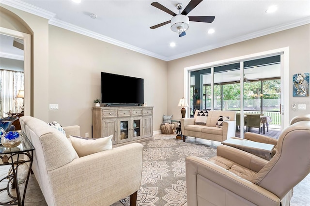 living room featuring carpet flooring, ceiling fan, and ornamental molding