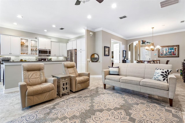 tiled living room featuring ceiling fan with notable chandelier and crown molding