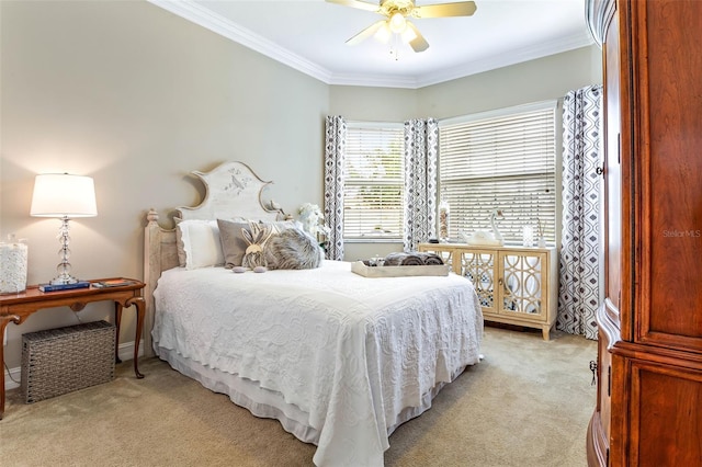 carpeted bedroom featuring ceiling fan and ornamental molding