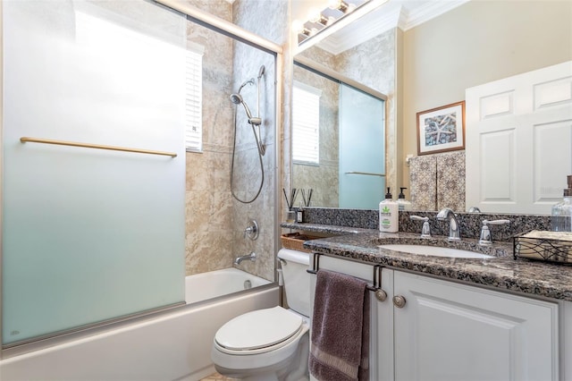 full bathroom with toilet, ornamental molding, combined bath / shower with glass door, and vanity