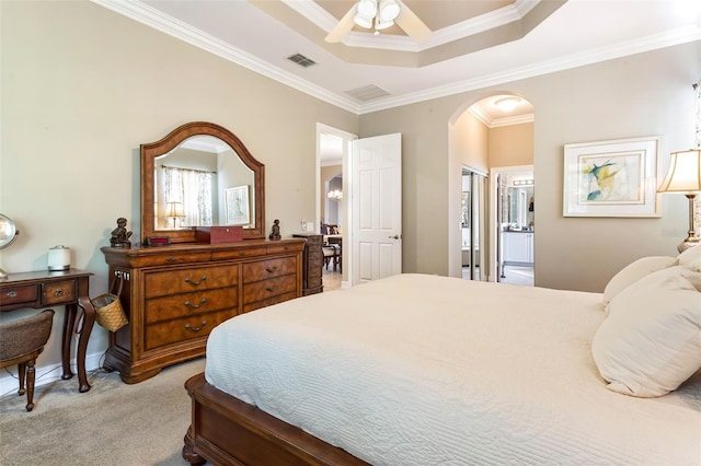 bedroom featuring ensuite bathroom, crown molding, a closet, carpet floors, and ceiling fan