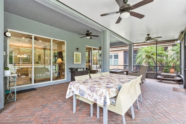 sunroom featuring ceiling fan