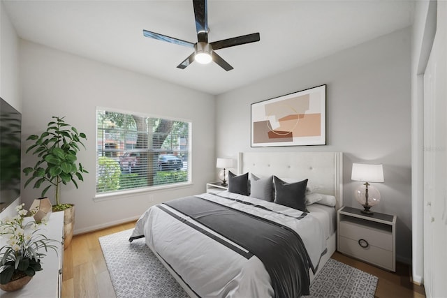 bedroom with light hardwood / wood-style flooring and ceiling fan