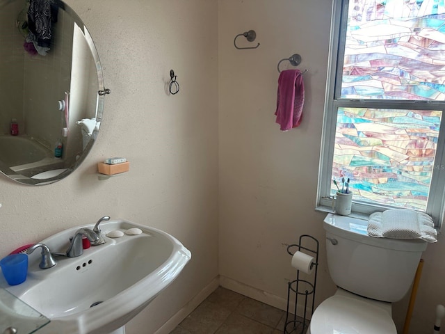 bathroom featuring tile patterned floors, sink, and toilet