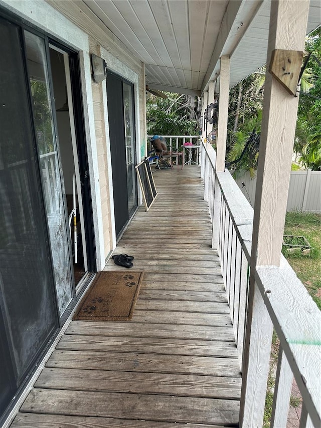 wooden terrace featuring covered porch