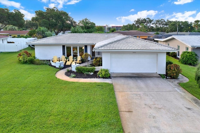 ranch-style house featuring a garage and a front yard