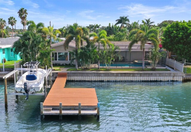 dock area featuring glass enclosure and a water view