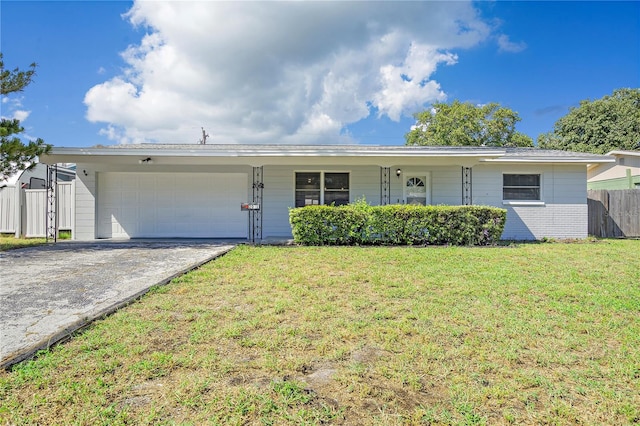 single story home featuring a garage and a front yard