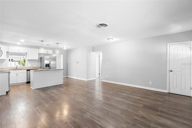 unfurnished living room with dark hardwood / wood-style flooring and sink