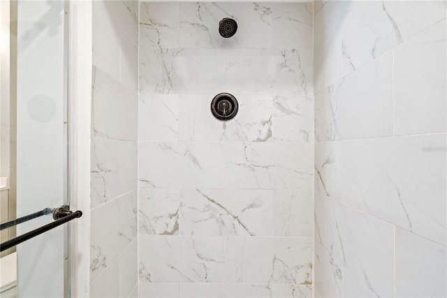 interior details with a tile shower