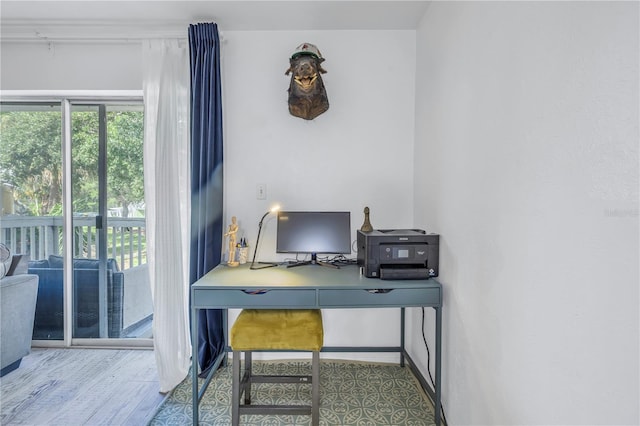 office with wood-type flooring and plenty of natural light