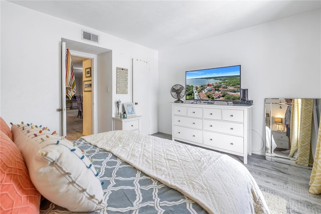 bedroom with wood-type flooring