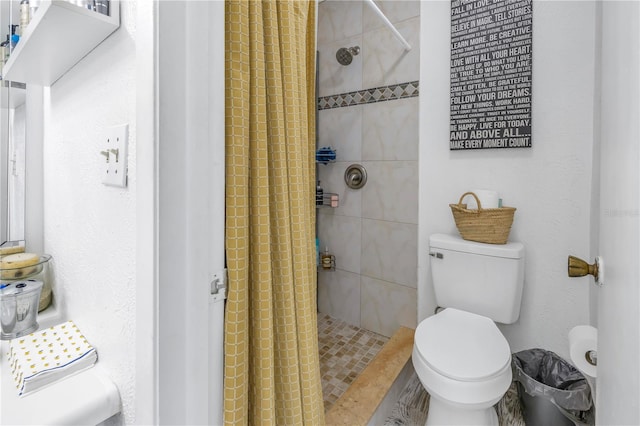 bathroom with a shower with curtain and toilet