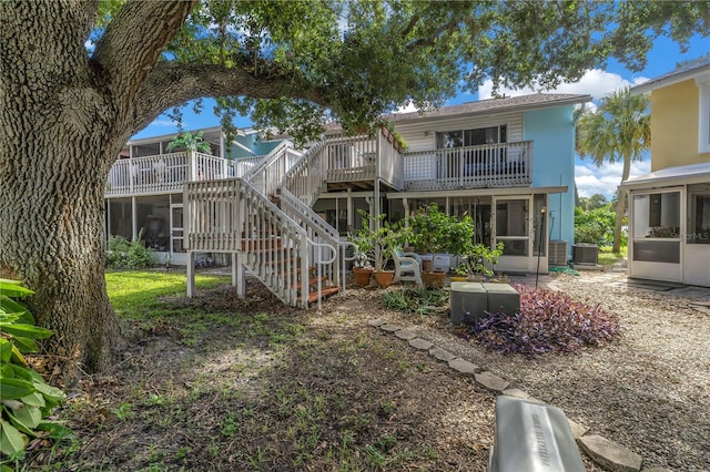 back of property with a patio area, a sunroom, and central AC unit