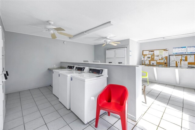 clothes washing area featuring washing machine and dryer, ceiling fan, and light tile patterned floors