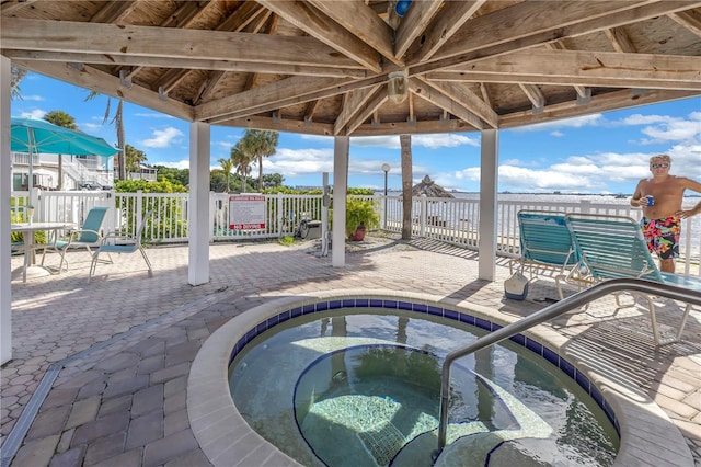 view of swimming pool featuring a hot tub, a patio area, and a gazebo