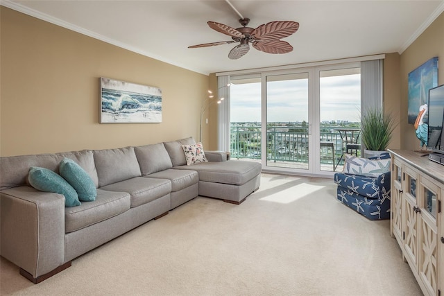 living room featuring ceiling fan, ornamental molding, and carpet floors