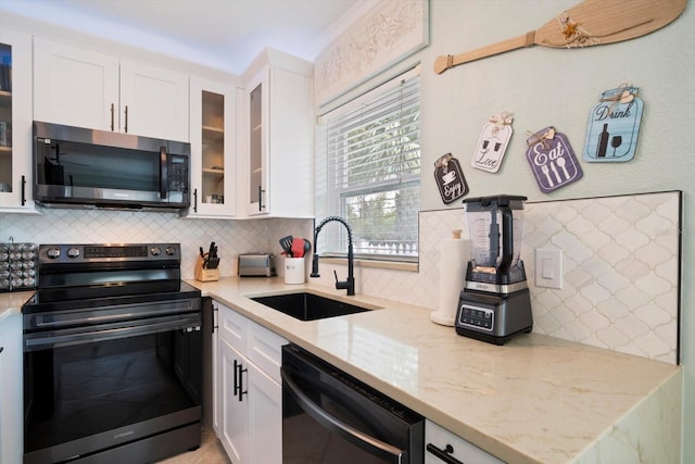 kitchen featuring appliances with stainless steel finishes, sink, and white cabinets