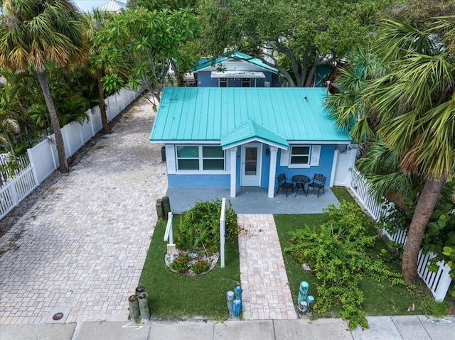 view of front of house featuring a front lawn and a patio area