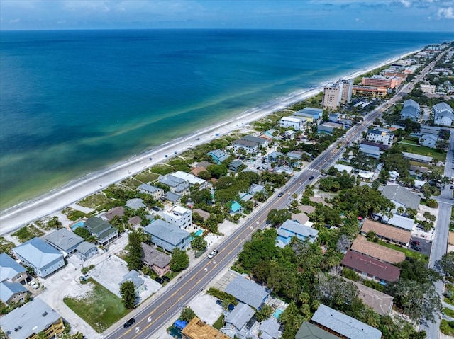 drone / aerial view with a water view and a beach view