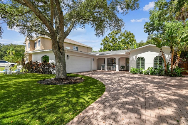 view of front facade featuring a front yard and a garage