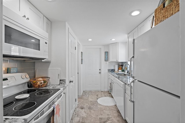 kitchen featuring decorative backsplash, white appliances, sink, and white cabinets