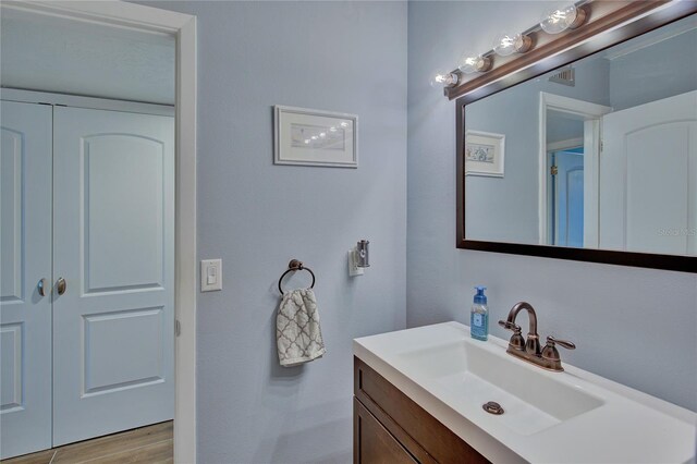 bathroom with vanity and wood-type flooring