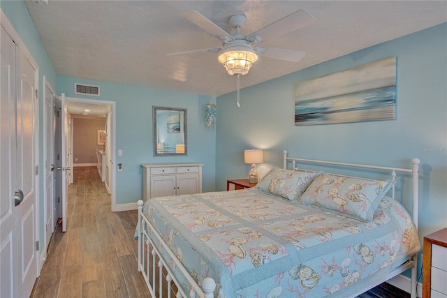 bedroom featuring light wood-type flooring and ceiling fan