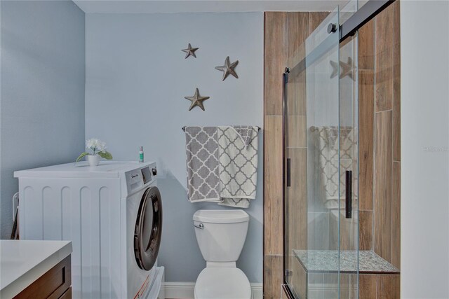 bathroom with washer / clothes dryer, vanity, toilet, and an enclosed shower