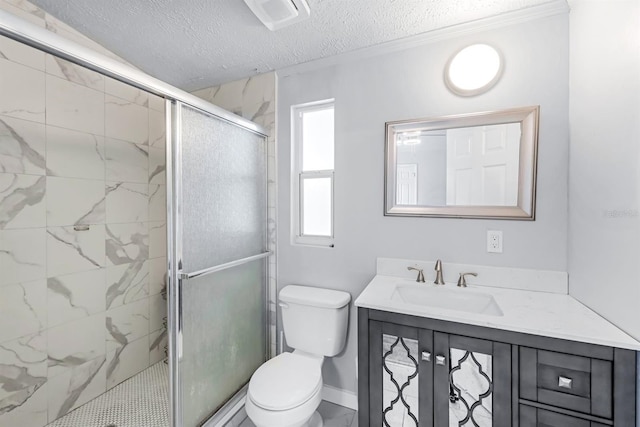 bathroom with a shower with door, vanity, toilet, and a textured ceiling