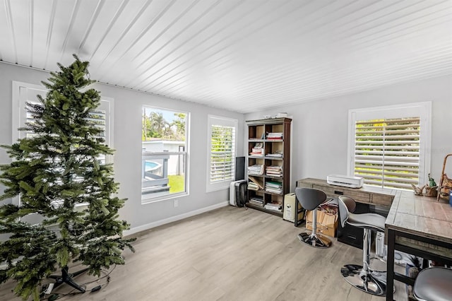 office area featuring baseboards and light wood-style flooring