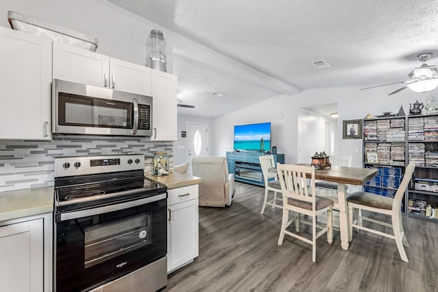 kitchen with appliances with stainless steel finishes, white cabinetry, and ceiling fan