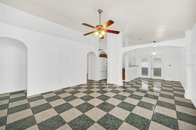 unfurnished living room featuring french doors, ceiling fan, and lofted ceiling