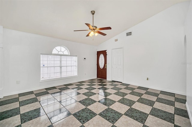 foyer with ceiling fan and high vaulted ceiling