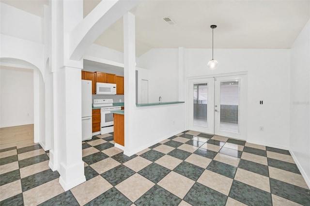 interior space featuring french doors and high vaulted ceiling