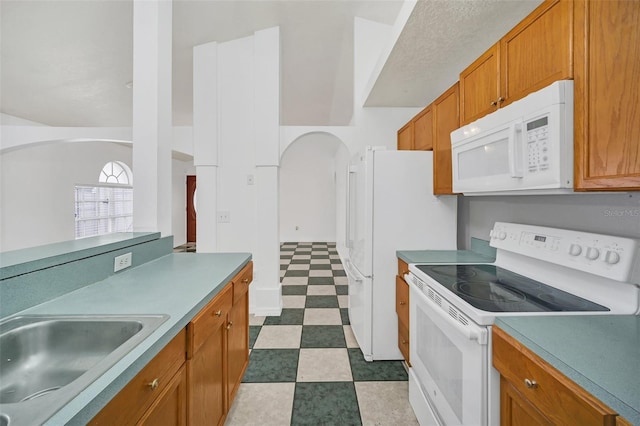 kitchen with white appliances and sink