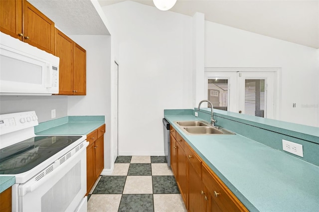 kitchen featuring lofted ceiling, white appliances, sink, and french doors