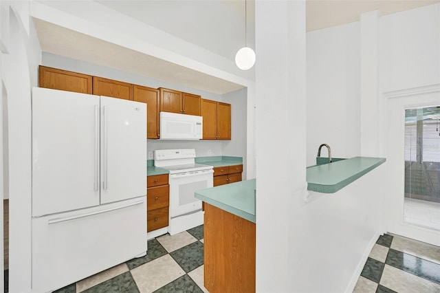 kitchen featuring pendant lighting and white appliances