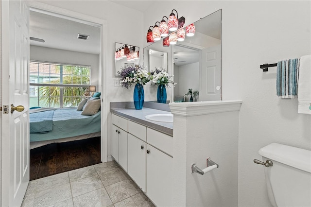 bathroom with tile patterned floors, vanity, and toilet