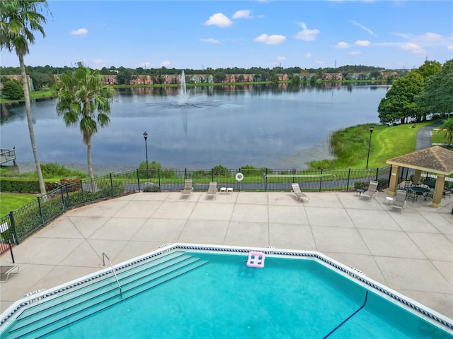 view of swimming pool with a gazebo, a patio area, and a water view