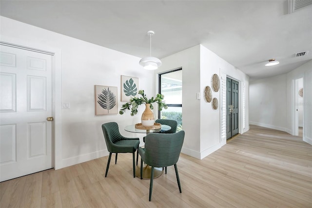 dining space featuring light wood-type flooring