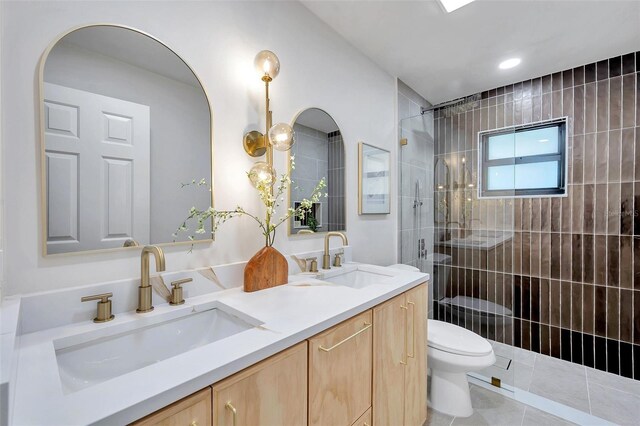 bathroom with tile patterned flooring, vanity, toilet, and walk in shower