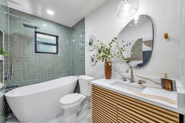 full bathroom featuring toilet, shower with separate bathtub, and vanity