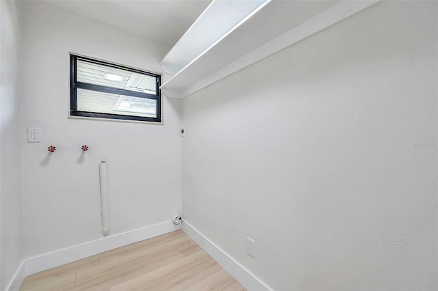 laundry room with hookup for a washing machine and light hardwood / wood-style floors