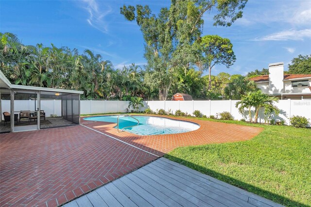 view of pool featuring a lawn and a patio