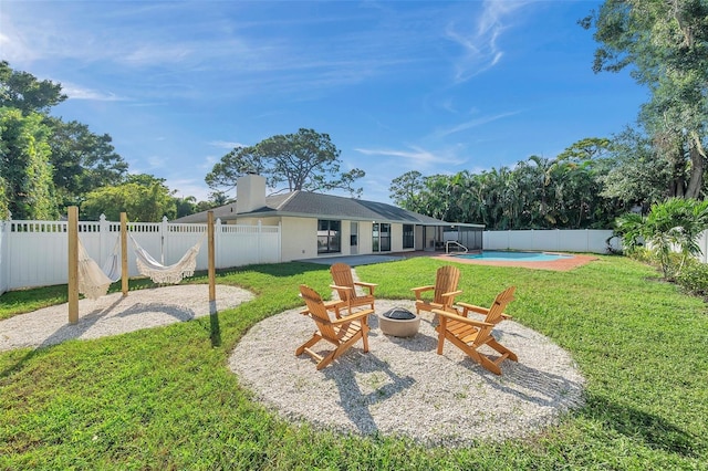 view of yard with a fenced in pool, a patio, and an outdoor fire pit