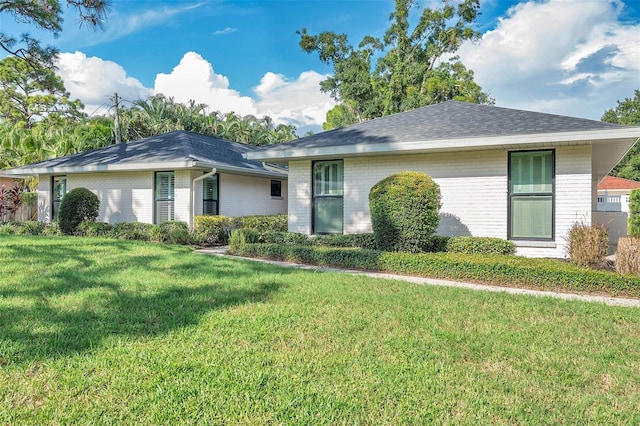 ranch-style house with a front lawn