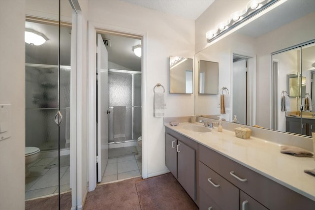 bathroom featuring vanity, toilet, and an enclosed shower